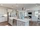 Modern kitchen features an island, stainless steel appliances, and an open floor plan to the living area at 13304 Chopin Ridge Dr, Huntersville, NC 28078