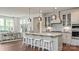 Bright kitchen features an island with seating, stainless steel appliances, and open access to the dining area at 13304 Chopin Ridge Dr, Huntersville, NC 28078
