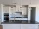 The spacious kitchen features stainless steel appliances, an island, and globe pendant lighting at 13304 Chopin Ridge Dr, Huntersville, NC 28078