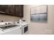 Convenient laundry room with modern appliances and storage cabinets at 13304 Chopin Ridge Dr, Huntersville, NC 28078