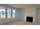 Inviting living room featuring a traditional fireplace and large windows offering plenty of natural light at 13304 Chopin Ridge Dr, Huntersville, NC 28078