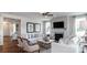 Bright living room featuring a fireplace, plush sofas, and stylish decor at 13304 Chopin Ridge Dr, Huntersville, NC 28078