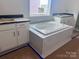 Relaxing bathroom features a soaking tub, white cabinets and sleek countertops at 13304 Chopin Ridge Dr, Huntersville, NC 28078