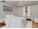 This primary bedroom has a large bed with white bedding, a neutral wall color, and light hardwood floors at 1331 Mccorkle Rd, Charlotte, NC 28214