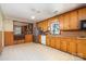 This open kitchen features custom wood cabinetry, updated appliances, and an open concept design at 1331 Mccorkle Rd, Charlotte, NC 28214