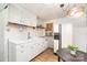Bright kitchen features white cabinetry, wood floors, modern appliances, and updated lighting at 1331 Mccorkle Rd, Charlotte, NC 28214