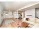 Cozy living room features a sofa, table, and kitchen area with wood floors at 1331 Mccorkle Rd, Charlotte, NC 28214