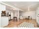 Cozy living room features a sofa, table, and kitchen area with wood floors at 1331 Mccorkle Rd, Charlotte, NC 28214