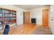 Bright office area with hardwood floors, bookshelf, and doors to other rooms at 1331 Mccorkle Rd, Charlotte, NC 28214