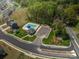 Community pool and recreation area with surrounding neighborhood, trees, and parking at 1347 Mifflin Ln, Dallas, NC 28034