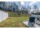 Large fenced backyard with lush green grass, trees, and a patio, providing privacy and space for outdoor activities at 1347 Mifflin Ln, Dallas, NC 28034
