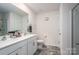 Modern bathroom with double sink vanity, tiled floor, large mirror and separate toilet area at 1347 Mifflin Ln, Dallas, NC 28034