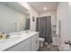 Bright bathroom featuring double sinks, a large mirror and a shower/tub combo with gray shower curtain at 1347 Mifflin Ln, Dallas, NC 28034