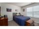 Comfortable bedroom with a gray upholstered headboard and neutral carpet with ample natural light at 1347 Mifflin Ln, Dallas, NC 28034