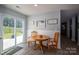 Bright dining area featuring a round wooden table, two chairs, and sliding glass doors to the outside at 1347 Mifflin Ln, Dallas, NC 28034