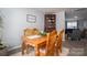 Bright dining area with a wooden table, seating for four, and a corner cabinet at 1347 Mifflin Ln, Dallas, NC 28034