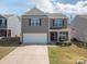 Charming two-story home with gray siding, a front porch, and an attached garage with ample parking at 1347 Mifflin Ln, Dallas, NC 28034