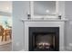 Close-up of a cozy fireplace with a decorative mantel and warm ambiance at 1347 Mifflin Ln, Dallas, NC 28034