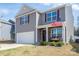 Charming two-story home featuring a covered front porch and a two-car garage at 1347 Mifflin Ln, Dallas, NC 28034