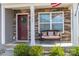 Inviting front porch with stone details, a bench, and a welcoming front door at 1347 Mifflin Ln, Dallas, NC 28034