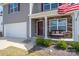 Close-up of a house featuring a covered porch with stone accents and a bench at 1347 Mifflin Ln, Dallas, NC 28034