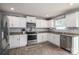 Well-lit kitchen featuring white cabinetry, stainless steel appliances, and a functional layout at 1347 Mifflin Ln, Dallas, NC 28034