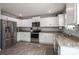 Modern kitchen with white cabinets, granite countertops, and stainless steel appliances at 1347 Mifflin Ln, Dallas, NC 28034