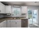 Well-lit kitchen featuring granite countertops, stainless steel appliances, and sliding glass door to patio at 1347 Mifflin Ln, Dallas, NC 28034