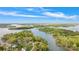 Stunning aerial view of lakefront property surrounded by lush greenery and expansive blue skies at 143 Ross Rd, Mooresville, NC 28117