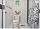Bathroom with a toilet, octagon window, black and white towel, and a glass-walled shower at 143 Ross Rd, Mooresville, NC 28117