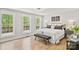 Bright bedroom with large windows and a view to the outdoors, hardwood floors, and neutral decor at 143 Ross Rd, Mooresville, NC 28117