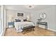 Bedroom with wood floors and decor, including a comfy bench and round mirror at 143 Ross Rd, Mooresville, NC 28117