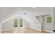 Bright attic bedroom with light-colored hardwood floors and multiple windows at 143 Ross Rd, Mooresville, NC 28117