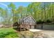 Charming home with a spacious deck, garage, and a beautifully landscaped yard surrounded by lush trees at 143 Ross Rd, Mooresville, NC 28117
