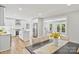 Open-concept living space connecting kitchen and dining area with views to outside at 143 Ross Rd, Mooresville, NC 28117