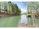Waterfront view showcasing a dock with ladder for lake access in a serene spot at 143 Ross Rd, Mooresville, NC 28117