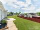 A spacious backyard is fenced in with a large grassy area and view of neighboring homes at 15 Wright St, Rock Hill, SC 29730
