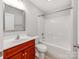 Bathroom with cherry vanity, white countertops, tub, and shower at 15 Wright St, Rock Hill, SC 29730