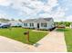 Inviting single-story home with a well-kept lawn, a paved driveway, and classic architectural details at 15 Wright St, Rock Hill, SC 29730