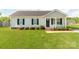 Charming single-story home featuring a well-manicured lawn, classic black shutters, and a welcoming entrance at 15 Wright St, Rock Hill, SC 29730
