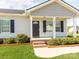 Welcoming front porch with brick steps, white columns, and landscaped bushes flanking the entrance at 15 Wright St, Rock Hill, SC 29730