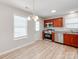 Bright kitchen featuring cherry wood cabinets, stainless steel appliances, and a modern wood-look floor at 15 Wright St, Rock Hill, SC 29730