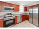 Modern kitchen featuring stainless steel appliances, cherry wood cabinets, and a sleek, granite countertop at 15 Wright St, Rock Hill, SC 29730