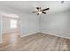 Bright, airy living room with light-colored walls, wood-look floors, and a modern ceiling fan at 15 Wright St, Rock Hill, SC 29730
