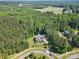 Aerial view of a home nestled in a lush, green, wooded area of mature trees at 15210 Pavilion Valley Cir, Huntersville, NC 28078