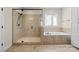 Bathroom featuring a glass-enclosed shower, soaking tub, and tile surround at 15210 Pavilion Valley Cir, Huntersville, NC 28078