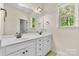 Bright bathroom features a double vanity, white cabinets, and stylish fixtures at 15210 Pavilion Valley Cir, Huntersville, NC 28078