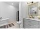 Modern bathroom with soaking tub, tiled floor, updated vanity and fixtures, and shiplap walls at 15210 Pavilion Valley Cir, Huntersville, NC 28078