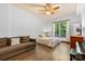 Cozy bedroom with hardwood floors, a ceiling fan, and a large window with bright, wooded views at 15210 Pavilion Valley Cir, Huntersville, NC 28078