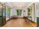 Bright dining room with hardwood floors, large windows with wooded views, and a chandelier at 15210 Pavilion Valley Cir, Huntersville, NC 28078